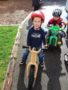 preschoolers_on_tricycles_with_helmets_cadence_academy_preschool_yelm_2_olympia_wa-338x450