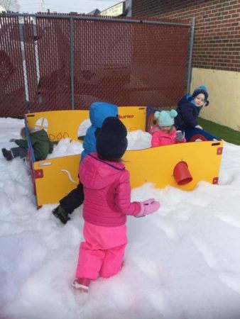 preschoolers_playing_in_snow_at_cadence_academy_preschool_norwood_ma-338x450