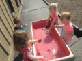preschoolers_playing_with_dinosaurs_and_water_rogys_learning_place_pekin_il-600x450