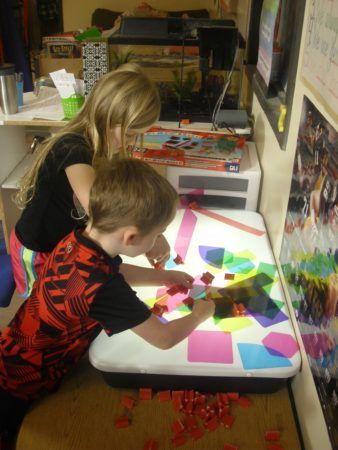 preschoolers_playing_with_light_box_cadence_academy_preschool_iowa_city_ia-338x450