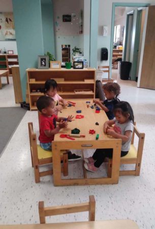 preschoolers_playing_with_playdough_smaller_scholars_montessori_academy_grisby_tx-305x450
