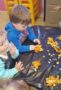 preschoolers_playing_with_pumpkin_seeds_prime_time_early_learning_centers_middletown_ny-305x450