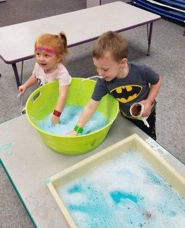 preschoolers_playing_with_soapy_water_rogys_learning_place_east_peoria_il-365x450