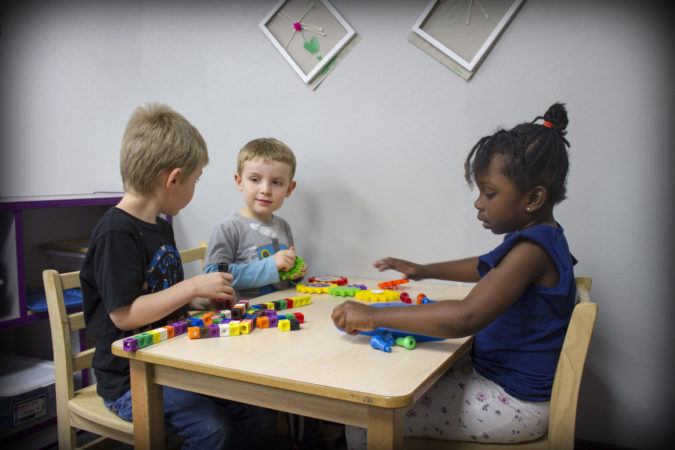 preschoolers_playing_with_stacking_blocks_rogys_learning_place_east_peoria_il-675x450