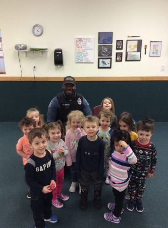 preschoolers_posing_with_policeman_next_generation_childrens_centers_andover_ma-333x450