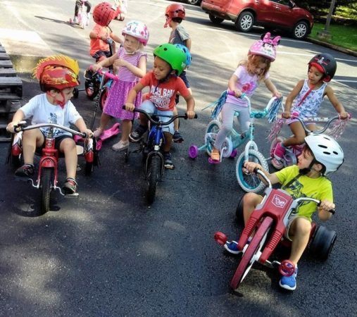 preschoolers_riding_bikes_at_cadence_academy_preschool_franklin_tn-507x450