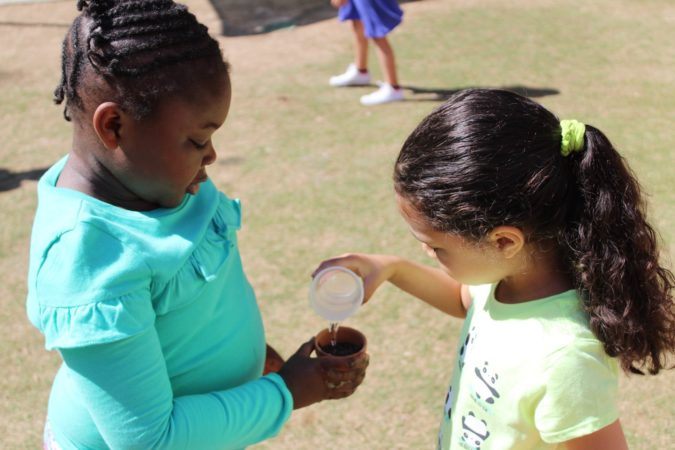 preschoolers_watering_plant_sunbrook_academy_at_stilesboro_kennesaw_ga-675x450