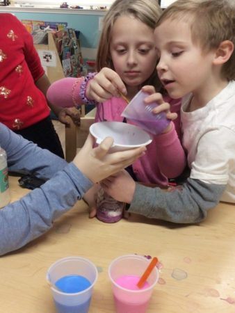 preschoolers_working_together_to_complete_paint_and_water_bottle_activity_cadence_academy_preschool_west_bridgewater_ma-338x450