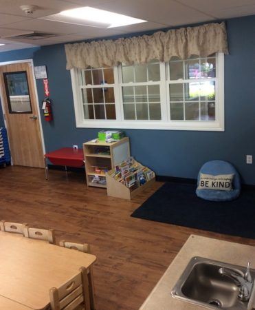 reading_area_with_be_kind_pillow_cadence_academy_preschool_west_bridgewater_ma-371x450