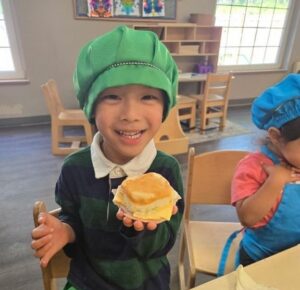 young child prepping a sandwich at cadence academy preschool and daycare in dupont washington