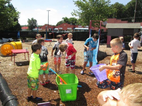 school_age_boys_playing_with_soapy_water_cadence_academy_preschool_greenville_sc-600x450