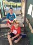 school_age_boys_sitting_on_playground_equipment_sunbrook_academy_at_woodstock_ga-336x450