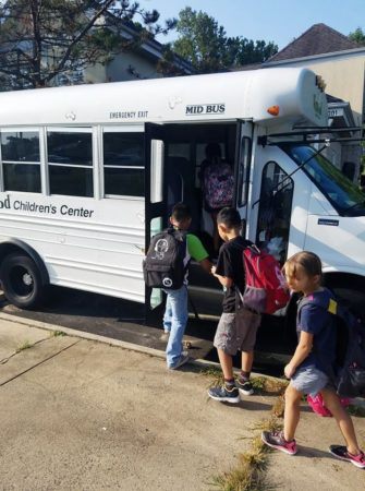 school_age_children_getting_on_bus_winwood_childrens_center_fairfax_va-335x450