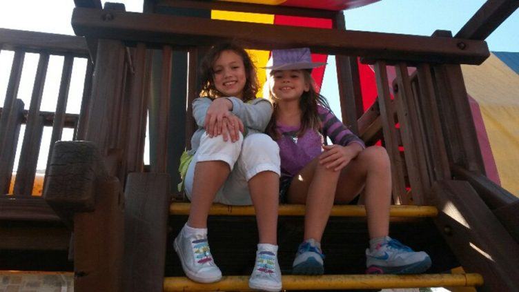 school_age_girls_on_playground_equipment_cadence_academy_preschool_allen_tx-752x423