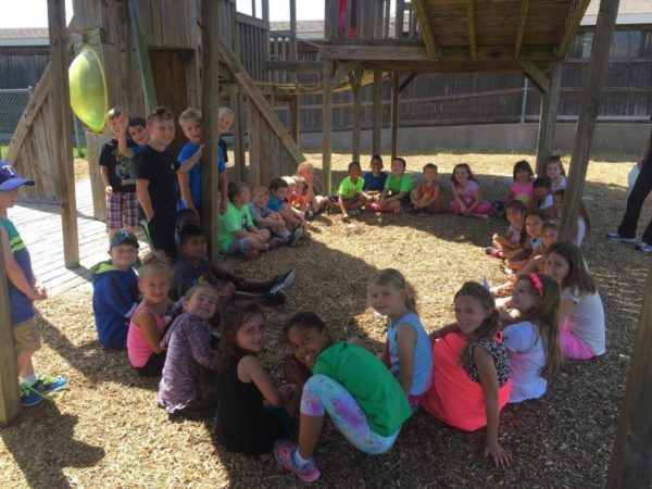 school_age_students_hanging_out_in_the_shade-600x450