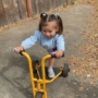 child riding a scooter outside in cadence academy preschool and daycare in dupont washington