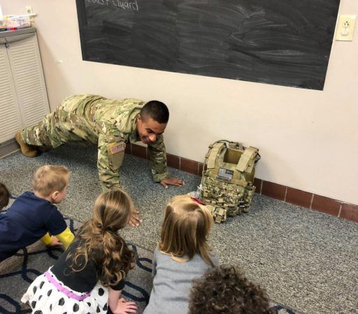 serviceman_doing_pushups_with_class_jonis_child_care_preschool_burlington_ct-512x450