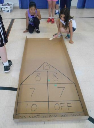 shuffleboard_game_cadence_academy_before_and_after_school_norwalk_ia-331x450