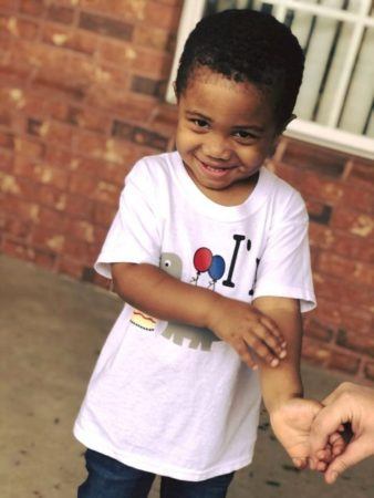 shy_preschool_boy_holding_hands_on_playground_sunbrook_academy_at_barnes_mill_austell_ga-338x450