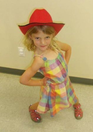 silly_preschool_girl_in_red_hat_cadence_academy_preschool_centennial_co-316x450