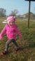 silly_preschool_girl_walking_on_the_grass_miss_muffets_learning_center_klamath_falls_or-253x450