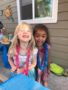 silly_preschool_girls_at_luau_cadence_academy_preschool_sellwood_portland_or-338x450