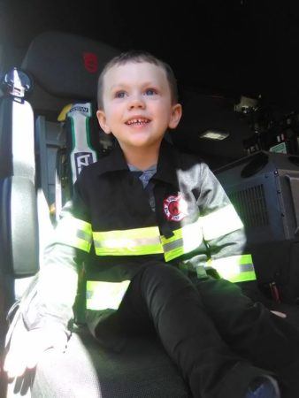 sitting_in_a_fire_truck_at_cadence_academy_preschool_franklin_tn-338x450