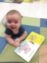 smiling_infant_enjoying_pig_book-creative_expressions_learning_center_imperial_mo-333x450