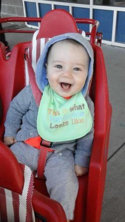 smiling_toddler_boy_sitting_in_stroller_prime_time_early_learning_centers_farmingdale_ny-253x450