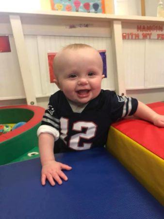 smiling_toddler_in_padded_play_area_cadence_academy_preschool_smithfield_ri-338x450