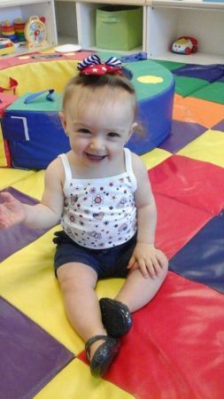 smiling_toddler_on_foam_mat_prime_time_early_learning_centers_paramus_nj-253x450