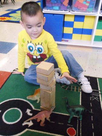 stacking_blocks_and_dinosaurs_at_cadence_academy_preschool_summerville_sc-336x450