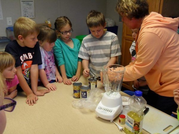 students_and_teacher_doing_a_cooking_activity_cadence_academy_before_and_after_school_norwalk_ia-600x450