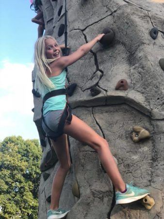 summer_camper_enjoying_climbing_a_rock_wall_cadence_academy_preschool_chesterfield_hilltown_mo-338x450