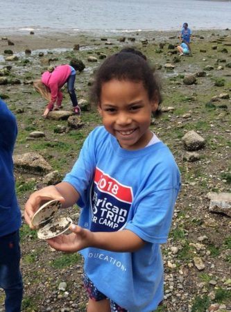 summer_camper_holding_clam_on_field_trip_cadence_academy_preschool_sleater-kinney_olympia_wa-333x450