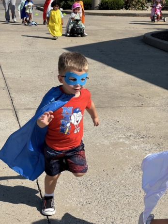 kids running around outside dressed up as superhero at preschool and daycare cadence academy preschool nolensville 504