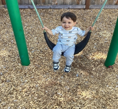 child swinging in playground at cadence academy preschool and daycare in dupont washington