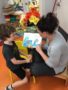 teacher_and_preschool_boy_reading_cat_surfing_book_fredericksburg_childrens_academy_fredericksburg_va-338x450