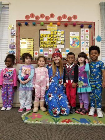 teacher_and_preschool_children_in_pajamas_at_cadence_academy_preschool_grand_prairie_tx-338x450