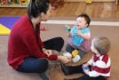 teacher_and_toddlers_playing_with_cars_cadence_academy_preschool_east_greenwich_ri-669x450