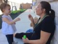 teacher_blowing_bubbles_with_2-year-old_cadence_academy_preschool_austin_cedar_park_tx-602x450