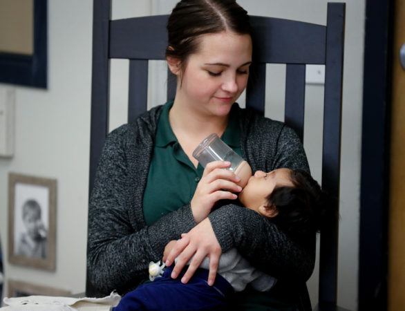 teacher_bottle_feeding_infant_cadence_academy_romeoville_il-586x450