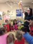 teacher_pouring_paint_during_science_activity_cadence_academy_preschool_dupont_wa-341x450