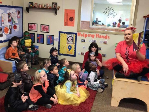teacher_reading_book_to_preschoolers_in_halloween_costumes_rogys_learning_place_morton_il-600x450