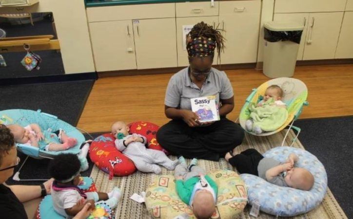 teacher_reading_to_infants_at_cadence_academy_preschool_dallas_tx-724x450