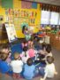 teacher_reading_to_preschoolers_cadence_academy_preschool_austin_tx-338x450