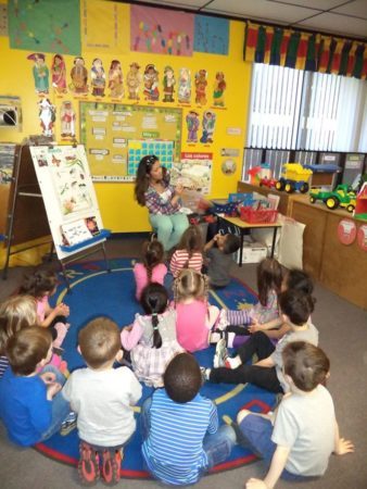 teacher_reading_to_preschoolers_cadence_academy_preschool_austin_tx-338x450