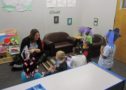 teacher_reading_to_preschoolers_in_elephant_hats_rogys_learning_place_lake_street_peoria_heights_il-632x450