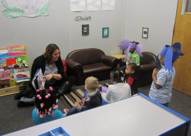 teacher_reading_to_preschoolers_in_elephant_hats_rogys_learning_place_lake_street_peoria_heights_il-632x450