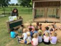 teacher_reading_to_preschoolers_outside_at_cadence_academy_preschool_rogers_ar-603x450